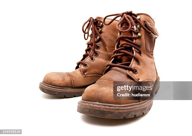 old brown boots isolated on white background - bruine laars stockfoto's en -beelden