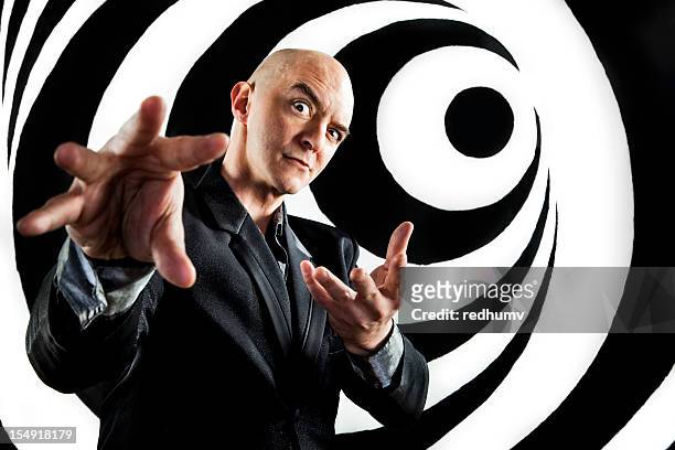 a hypnotist trying to control a person using his hands - hypnotherapy stock pictures, royalty-free photos & images