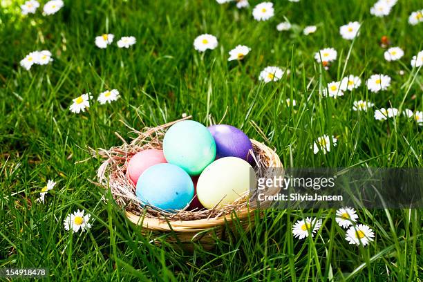 easter basket in grass - easter basket stock pictures, royalty-free photos & images