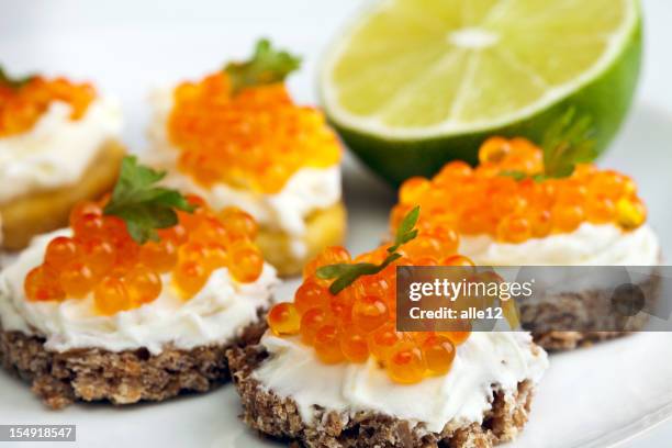 close-up of a plate of garnished caviar appetizers with lime - roes stock pictures, royalty-free photos & images