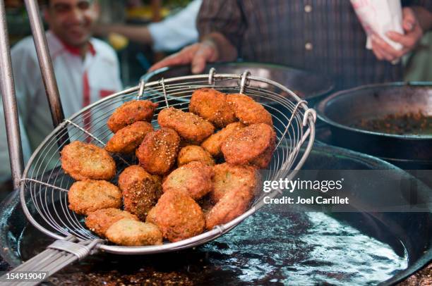 falafel lifted out of hot oil in cairo, egypt - egyptian stock pictures, royalty-free photos & images