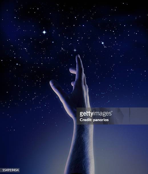 dark blue and black graphic of a hand reaching for stars - catching hands stock pictures, royalty-free photos & images