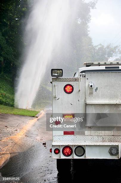 plumbing emergency vehicle at water pipe break location - burst pipe stockfoto's en -beelden