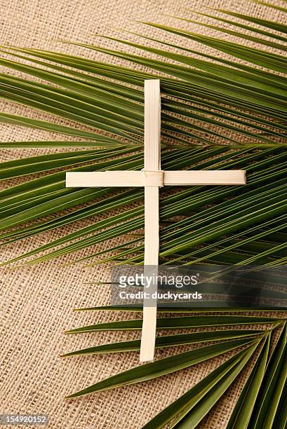palm cross and branches on burlap - palm sunday stock pictures, royalty-free photos & images