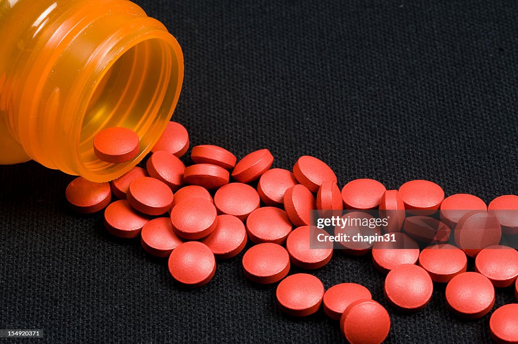 Pills Spilling Out Of Bottle