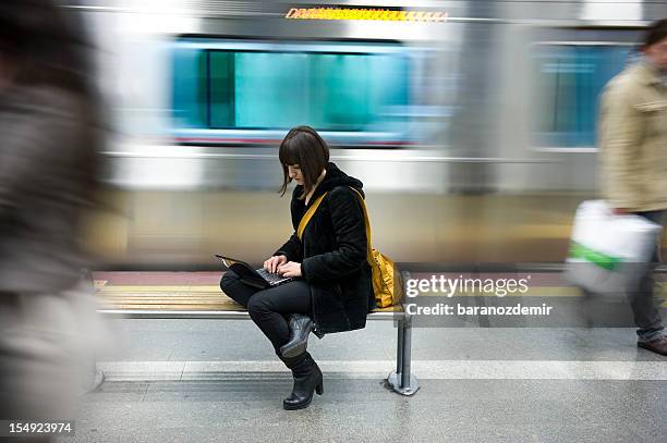 young woman in the subway station - action laptop stock pictures, royalty-free photos & images