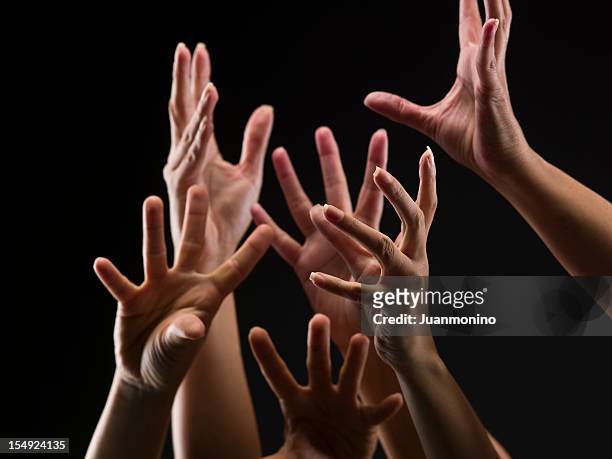 female hands reaching out - christianity black background stock pictures, royalty-free photos & images