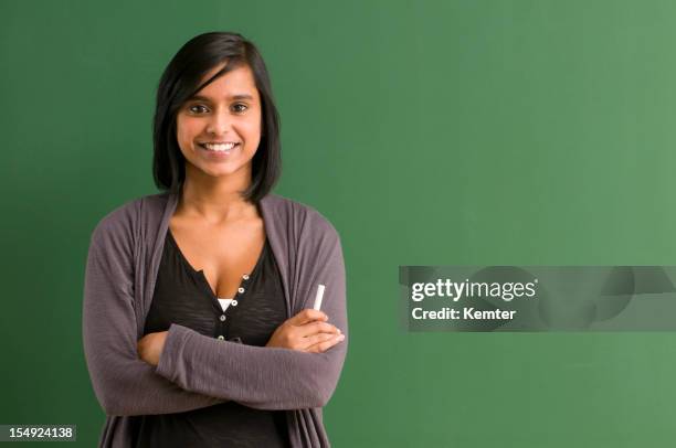 smiling student at blackboard - student coloured background stock pictures, royalty-free photos & images