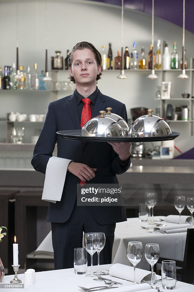 Waiter carrying serving tray in restaurant XXXL image