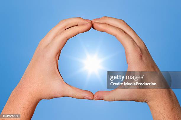 framed sun - human hand circle stock pictures, royalty-free photos & images