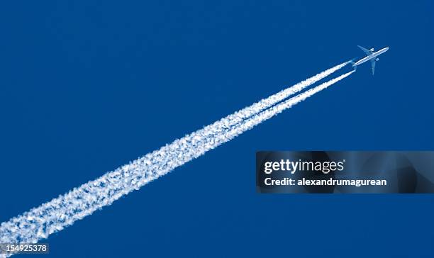 the contrail of a high speed airplane - vapour trail stock pictures, royalty-free photos & images