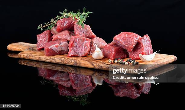 red meat on wooden board, against black background - beef bildbanksfoton och bilder