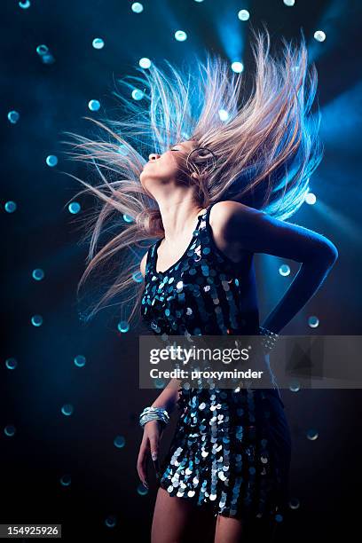 young women dancing on smoky disco background - girl swing stockfoto's en -beelden