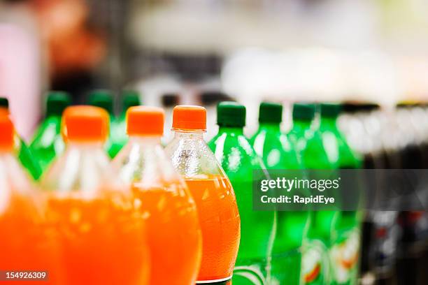 lots of soda bottles in various flavours all lined up - cola stockfoto's en -beelden