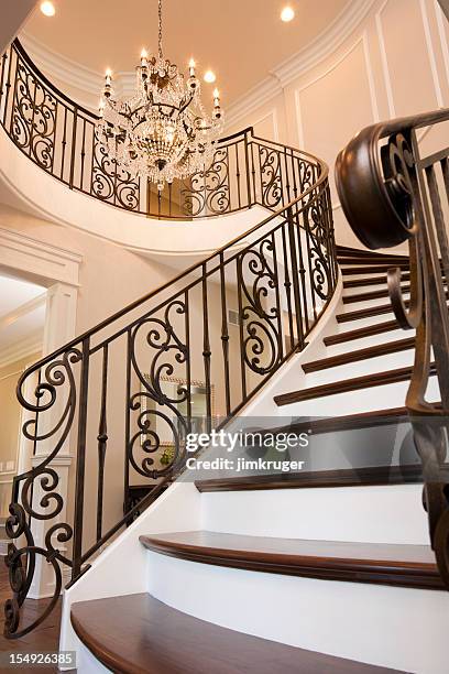 fancy spiral staircase and traditional chandelier - chandelier stock pictures, royalty-free photos & images