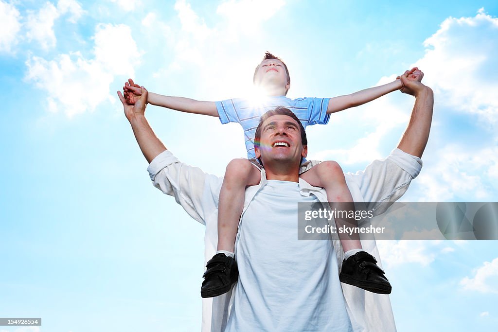 Father and son are enjoying at the blue sky.