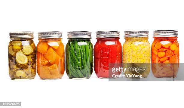 canning food jars of canned vegetables preserved in glass storage - canned goods stock pictures, royalty-free photos & images