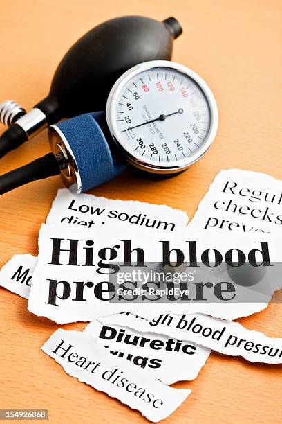 high blood pressure headlines with sphygmomanometer - high blood pressure stockfoto's en -beelden
