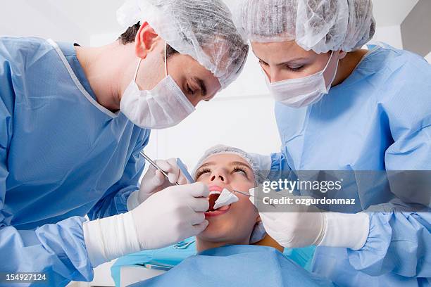 dentist's surgery - removing surgical mask stock pictures, royalty-free photos & images