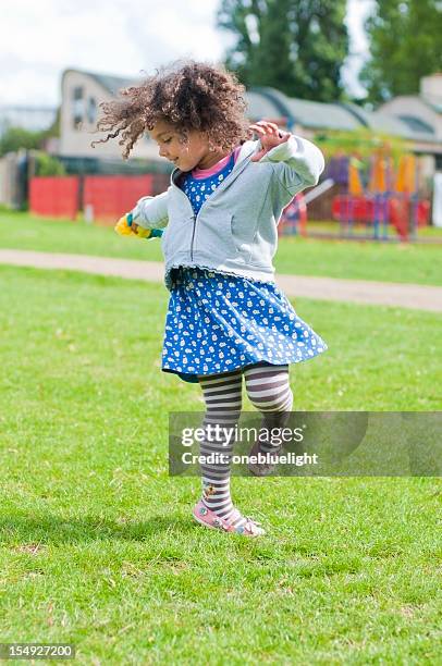child ( 4-5 ) goes round in circle - girl dancing alone stock pictures, royalty-free photos & images