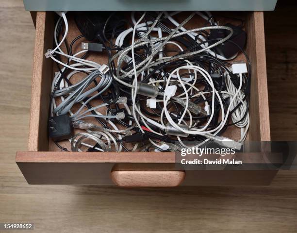 desk drawer filled with cables, wires and plugs - drawer stock pictures, royalty-free photos & images