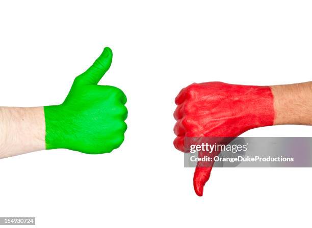 two hands one painted green and the other red showing signs - evil bildbanksfoton och bilder