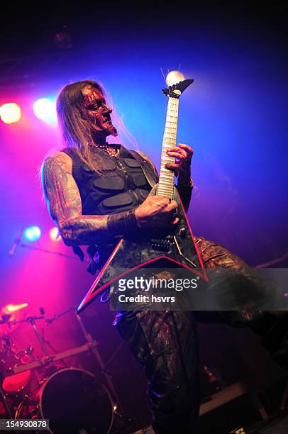 guitarrist and vocalist of metal band at club concert - heavy metal stock pictures, royalty-free photos & images