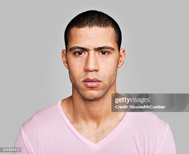 serious moroccan male in v neck shirt - v hals stockfoto's en -beelden
