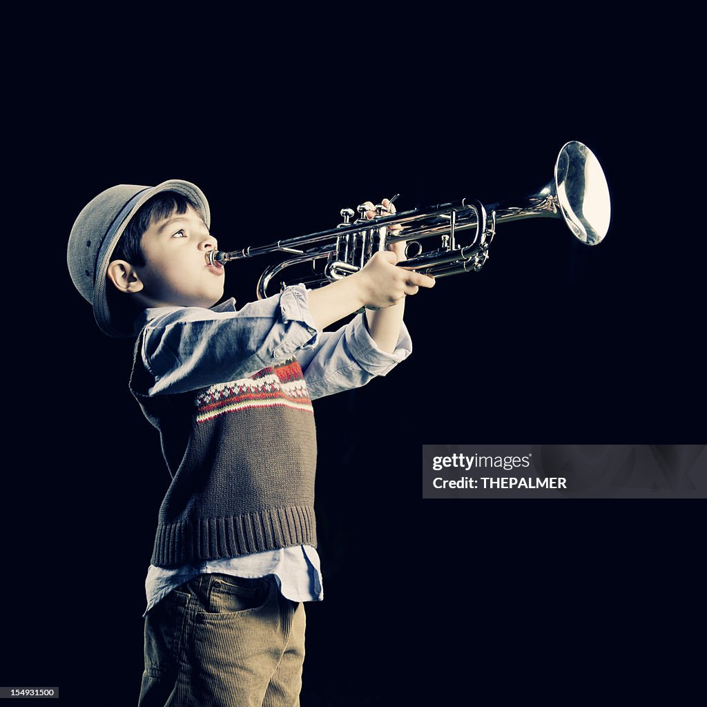 Four years old kid playing the trumpet