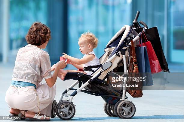 present - three wheeled pushchair stock pictures, royalty-free photos & images