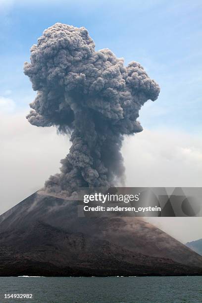 krakatau erupts plume of smoke - vulkaanlandschap stockfoto's en -beelden