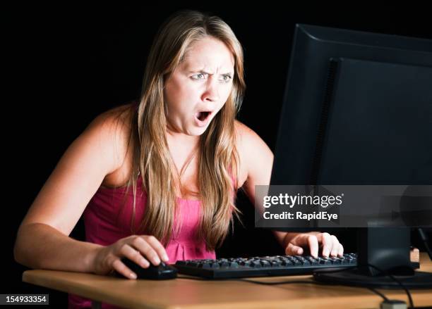 pretty blonde is shocked by what's on computer monitor - porr bildbanksfoton och bilder