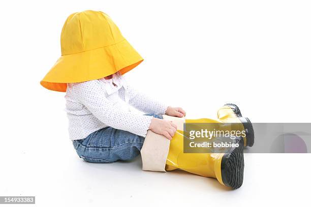 big shoe children: little girl in rain wear - rain hat stock pictures, royalty-free photos & images