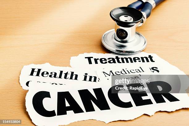 cancer headlines alongside stethoscope on desk - abc news stock pictures, royalty-free photos & images