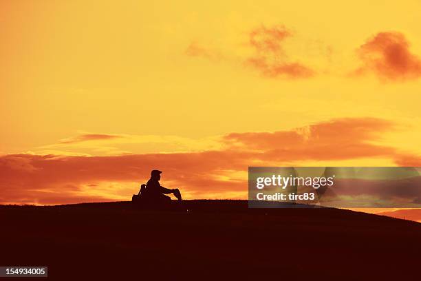 man in silhouette on mobility scooter - mobility scooter stock pictures, royalty-free photos & images