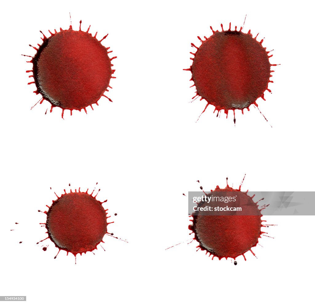 Isolated red ink splatter drops close-up