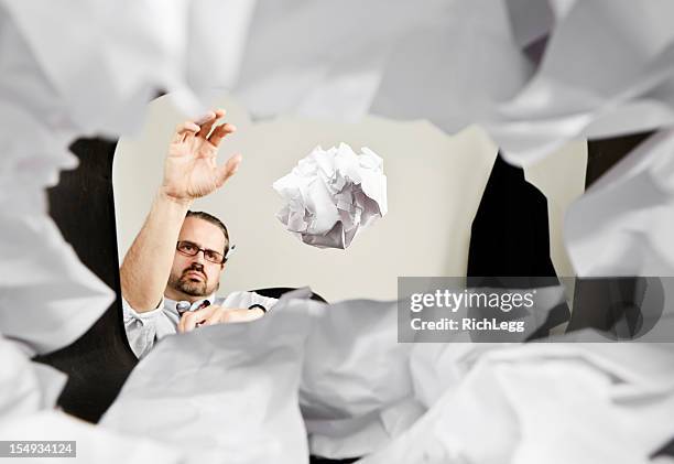 man throwing paper into wastepaper basket - throwing paper stock pictures, royalty-free photos & images