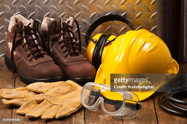 personal protective workwear on the floor - protective workwear stock pictures, royalty-free photos & images