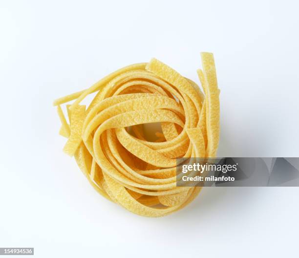 uncooked ribbon pasta - tagliatelle stock pictures, royalty-free photos & images