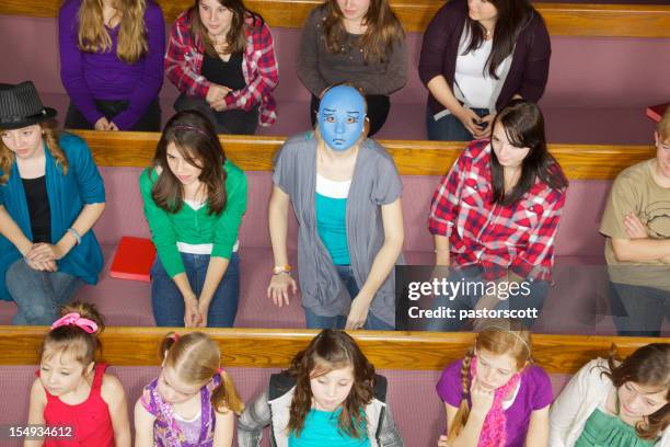 anonymous unwelcome visitor at church - alone in a crowd sad stockfoto's en -beelden