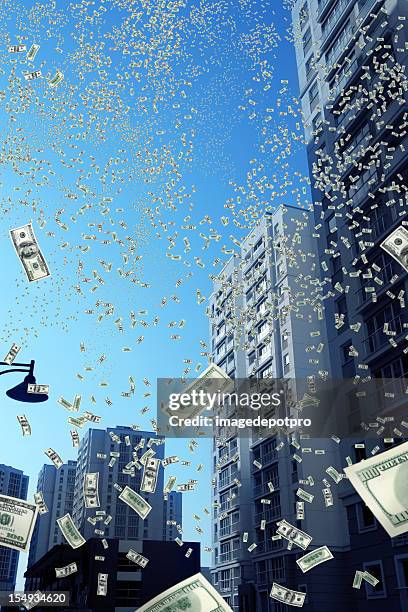 falling money in city - disney dollars stock pictures, royalty-free photos & images