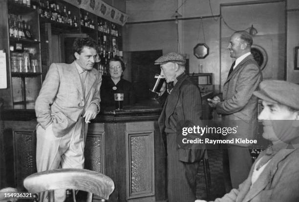 Welsh actor Richard Burton at the bar with with his father, Richard Jenkins, and his brother, Ifor Jenkins, at the Miner's Arms pub in his native...