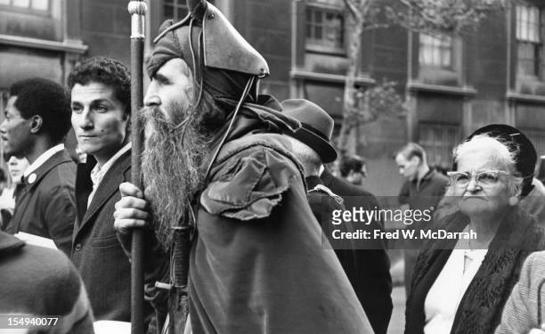 View of blind American composer, musician, poet, and eccentric Moondog as he participates in an Anti-Vietnam War march, New York, New York, October...