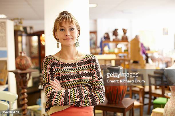 antique shop owner in her shop - antique shop stock pictures, royalty-free photos & images