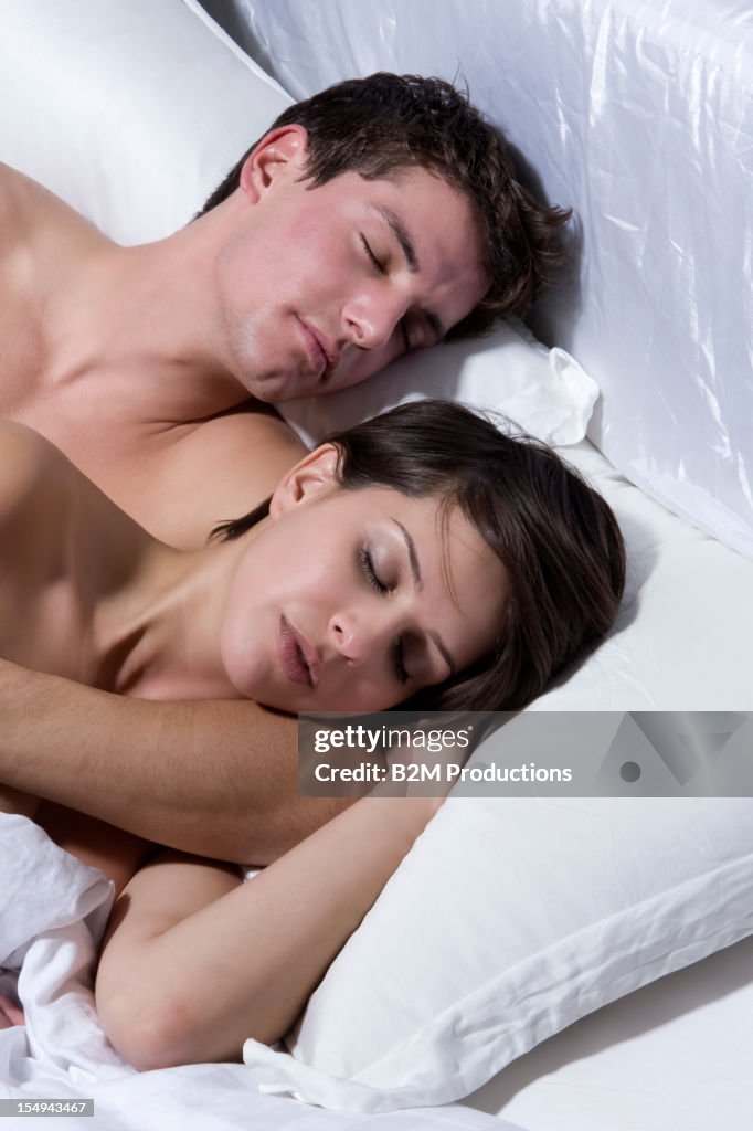 Young Couple Sleeping On Bed