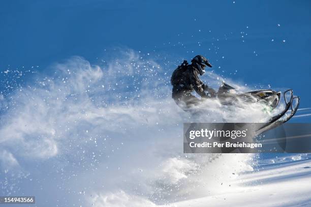 snowmobile jumping in the powder - snowmobiling stock pictures, royalty-free photos & images