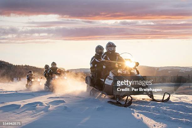 sunrise snowmobile touring - snowmobiling stock-fotos und bilder