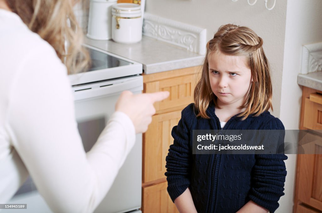 Angry girl scolded by her mother