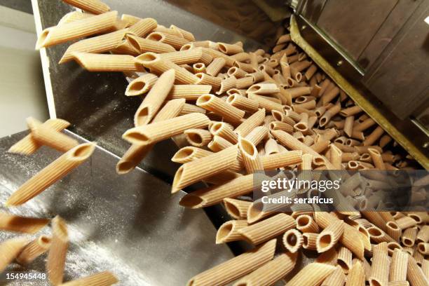 whole wheat pasta - whole wheat penne pasta stock pictures, royalty-free photos & images