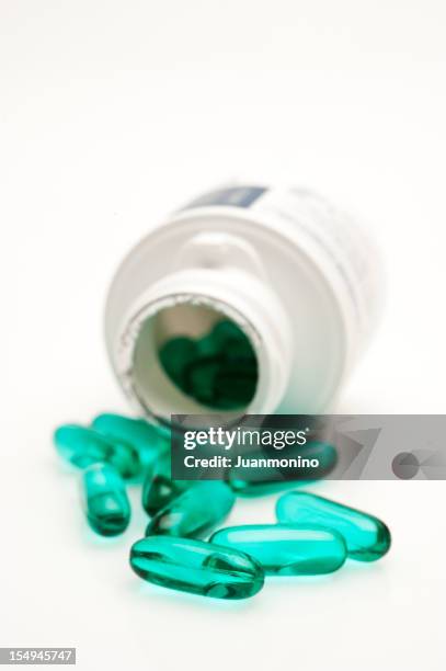 green gel capsules - ibuprofen stock pictures, royalty-free photos & images